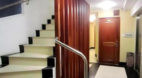 a hallway with stairs and a red door at An Dong Center Hotel Chinatown Saigon in Ho Chi Minh City