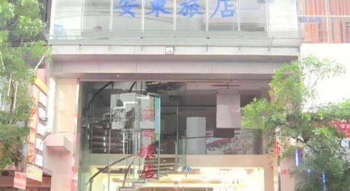 a window of a building with blue writing on it at An Dong Center Hotel Chinatown Saigon in Ho Chi Minh City