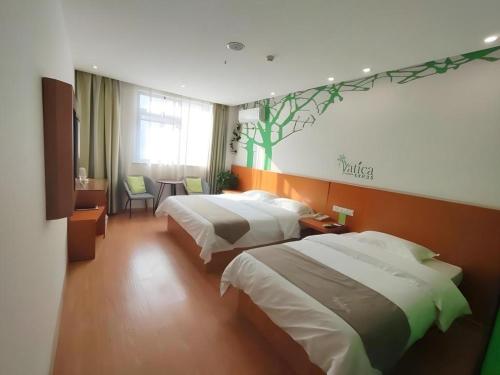 a hotel room with two beds and a table at Vatica HeFei Baishuiba BHG Hotel in Hefei