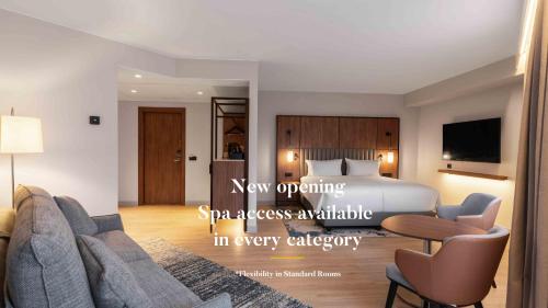 a bedroom with a bed and a living room at voco Stockholm - Kista by IHG in Stockholm