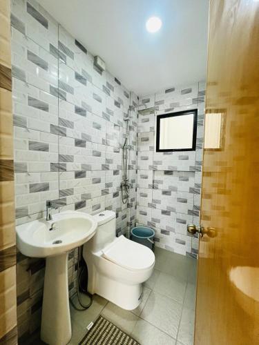a bathroom with a toilet and a sink at 4BR House in Pardo Cebu Perfect for Groups in Cebu City