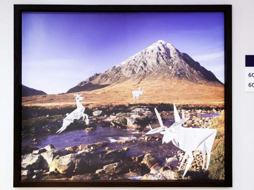 a painting of birds flying over a mountain at ibis Styles Edinburgh St Andrew Square in Edinburgh