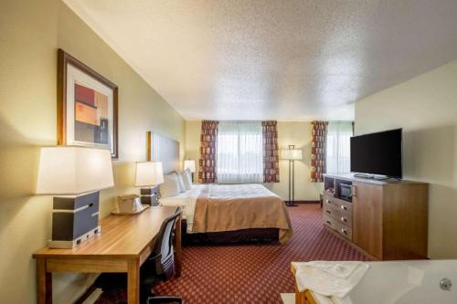 a hotel room with a bed and a desk at Quality Inn in Mineral Point