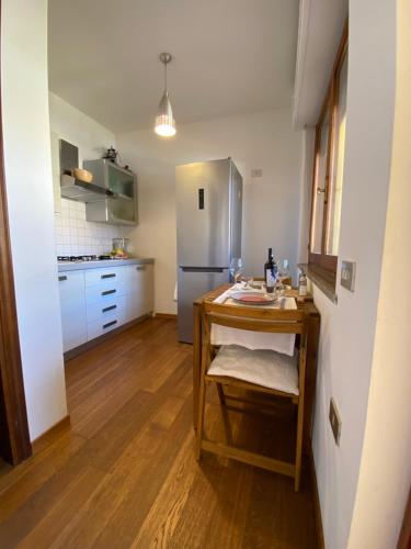 a kitchen with a table and a refrigerator at City House Cagliari in Cagliari
