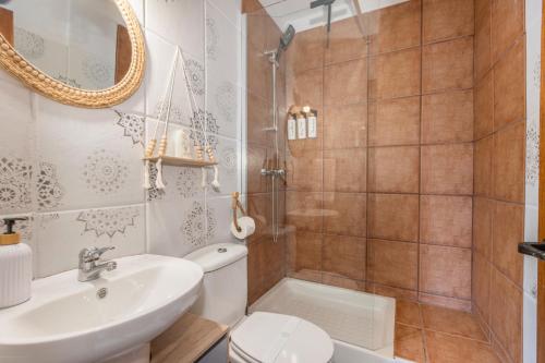 a bathroom with a sink and a toilet and a shower at La Rectoria de Vicfred in Palouet