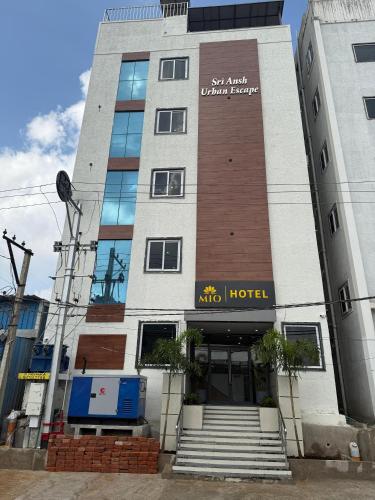 a hotel with a sign on the front of it at Mio Hotel in Hyderabad