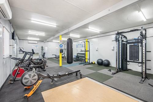a gym with weights and exercise equipment in a room at Alice Village in Alice Springs