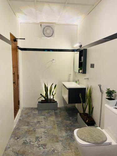 a bathroom with a toilet and a sink at Mountain Bliss - Ingiriya in Ingiriya
