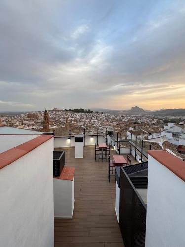 a view of a city from the roof of a building at Hotel Apartamentos Antequera in Antequera