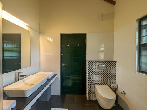 a bathroom with a tub and a toilet and a sink at Pine Tree Place By Luxunlock Private Villas in Ammatti