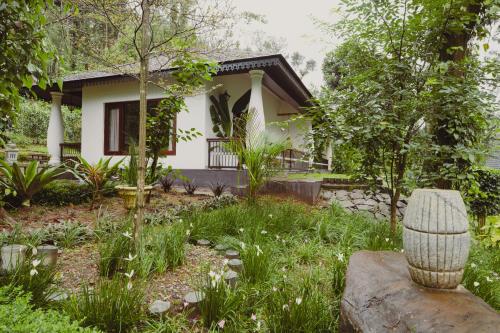 a house with a garden in front of it at The Wild Rest Nature Resort in Avathi