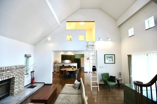 a living room with a couch and a fireplace at Private villa in the Shizuoka Highlands in Susono