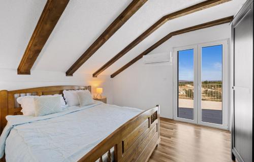 a bedroom with a bed and a large window at Villa MilaMar by Villas Guide in Lađevci
