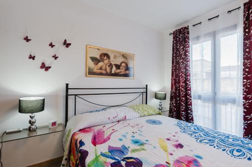 a bedroom with a bed and a window with butterflies on the wall at Casa Luna in Balestrate