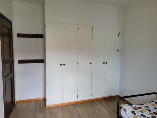 a room with white cabinets and a bed in it at Cozy & light-filled home in Landskrona