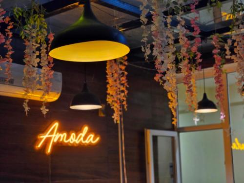 a group of lights hanging from the ceiling of a restaurant at Amoda - Best Hotel in Dharamshala in Dharamshala