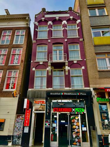 a tall building with a store in front of it at Orange Tulip Hotel in Amsterdam