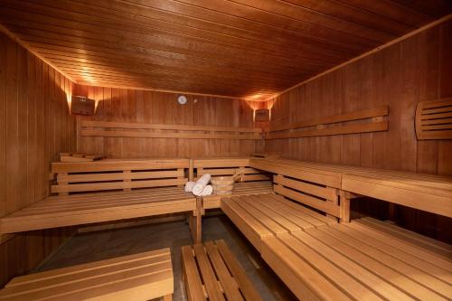 an empty wooden sauna with wooden benches in at Aparthotel am Reitecksee in Flachau