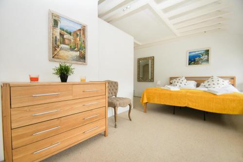 a bedroom with two beds and a dresser at Kemp Town Mews - Parking - by Brighton Holiday Lets in Brighton & Hove