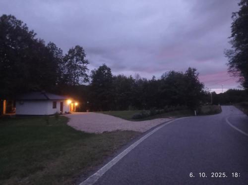 a house on the side of a road at night at Vikendica Šššuma in Srbac