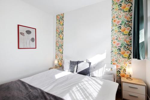 a bedroom with a white bed and a window at Albrechtshof Zimmer Parkblick 3 in Neu Fahrland