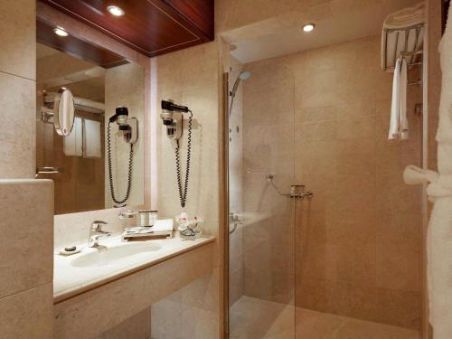 a bathroom with a sink and a shower at Pullman Zamzam Madina in Al Madinah