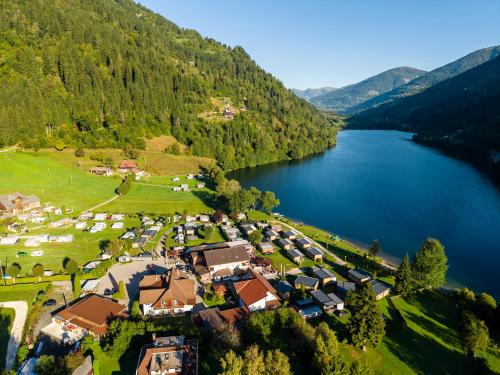 an aerial view of a village next to a lake at Fischerhof Glinzner Hotel-Restaurant-Camping in Afritz