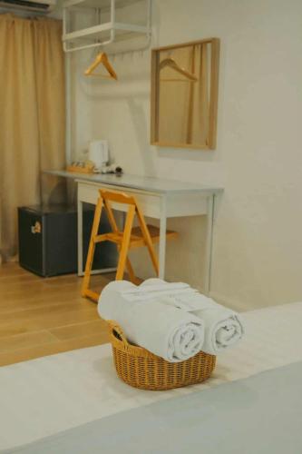 a kitchen with a basket of towels on the floor at Beluga koh Sichang in Ko Si Chang