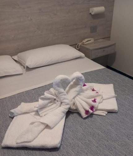 a room with two beds with towels on the floor at Hotel La Baia in Ponza