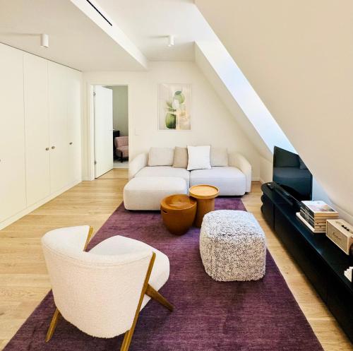 a living room with a couch and a table at Chic Loft by Castle&Danube Old town Free Parking in Bratislava