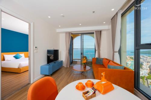 a living room with a bed and a couch at Solara Apartment Firework & Sunset View in Phú Quốc