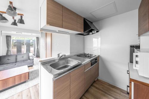 a kitchen with a sink and a counter top at SERAPHIC 千歳MS101 in Chitose