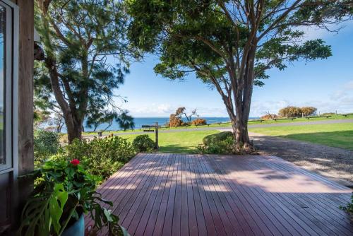 a walkway to a house with a view of the ocean at Pebble Views by Property Mums in Flinders