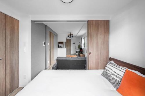 a bedroom with a bed and a living room at SERAPHIC 千歳MS101 in Chitose