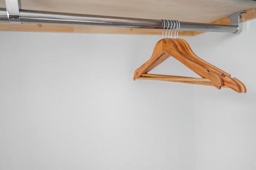 a measuring tool hanging from a wooden shelf at SERAPHIC 千歳MS101 in Chitose