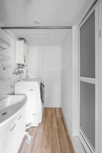 a bathroom with a sink and a washing machine at SERAPHIC 千歳MS101 in Chitose