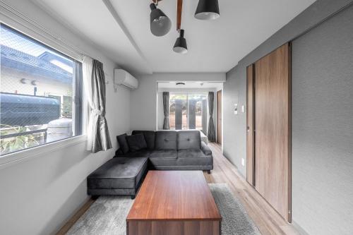 a living room with a couch and a table at SERAPHIC 千歳MS101 in Chitose