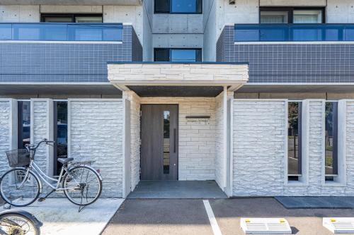 a bike parked in front of a building at SERAPHIC 千歳MS101 in Chitose