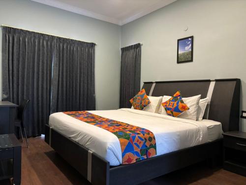 a bedroom with a large bed in a room at Ksr woodland Residency in Kodaikānāl