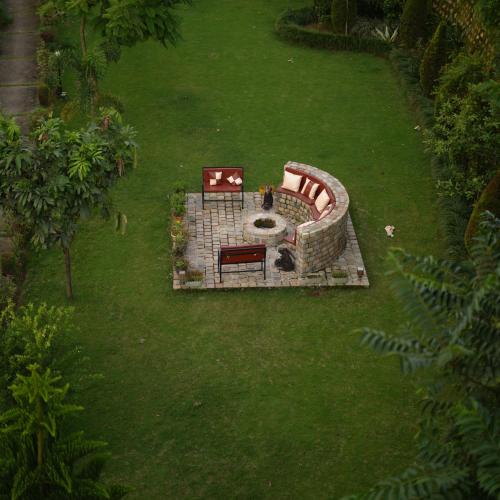 an aerial view of a garden with a bench and a table at Ekantam Resort in Kāta Patthar