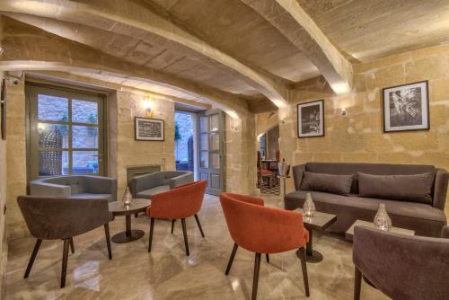 a living room with a couch and chairs at Palazzo Consiglia - IK Collection in Valletta