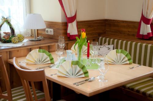 a wooden table with two chairs and a dining room at Landhaus Wilhelmer in Fohnsdorf