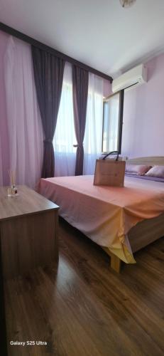 a bedroom with a bed with a suitcase on it at Divine place Majestic 90 in Pomorie