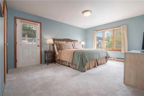 a bedroom with a bed and a window at RMR: Teewinot A2 Condo in Teton Village in Teton Village