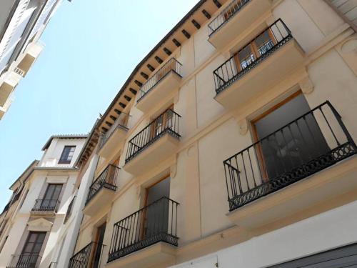 a building with balconies on the side of it at Apartamentos Silleria - A 4 min de la Catedral de Granada in Granada