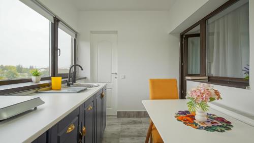 a kitchen with a counter with a vase of flowers on it at Vila Suveranii in Braşov