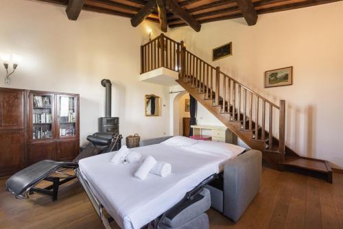 a bedroom with a bed and a staircase at Villa Bianca in Scandicci