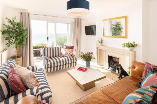 a living room with couches and a fireplace at NEW Luxury Beachfront House sleeps 8 Exmouth Devon in Exmouth
