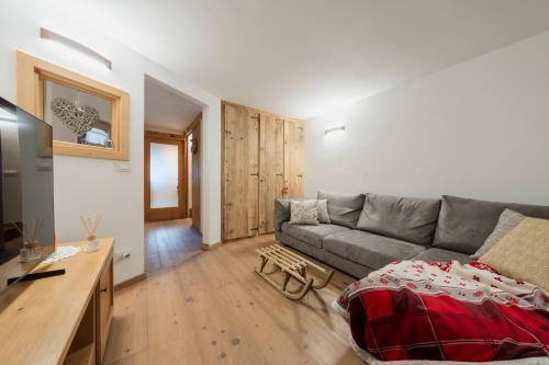 a living room with a couch and a table at Antico Fienile in Borca di Cadore