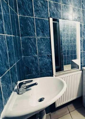 a bathroom with a sink and a mirror at Modern & Comfortable City Center Oasis~King Bed ! in Brussels